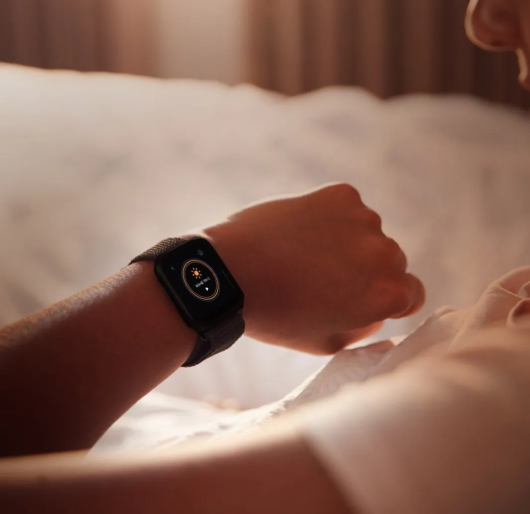 Woman checking her NiKKi activity and heart rate in the morning sun