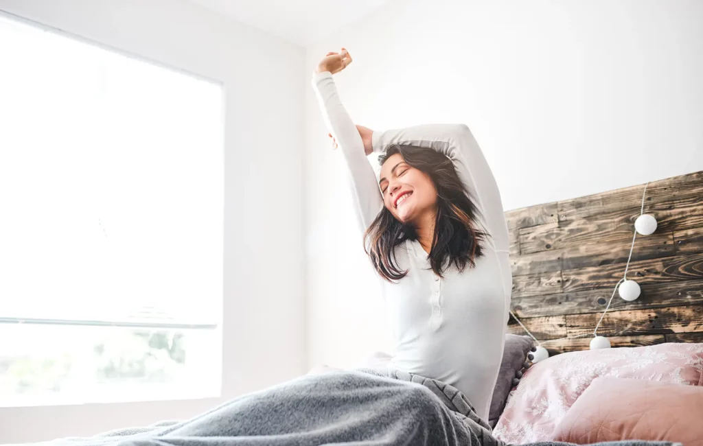 Woman waking up fresh from a great sleep